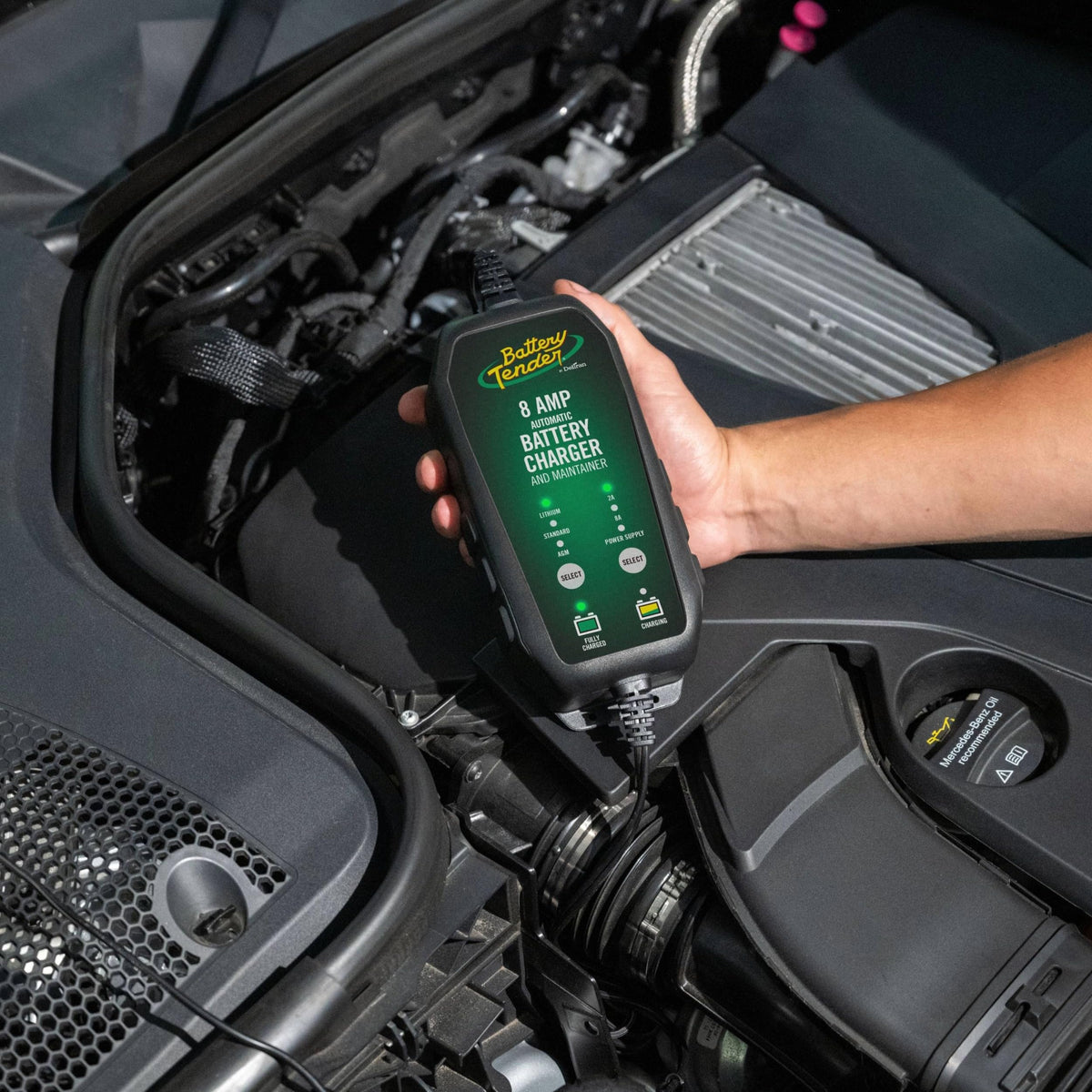 Battery Tender mounted on motorcycle battery during charging to maintain power and preserve settings