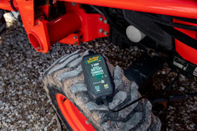 Battery Tender side profile next to a ruler demonstrating compact scale and portability
