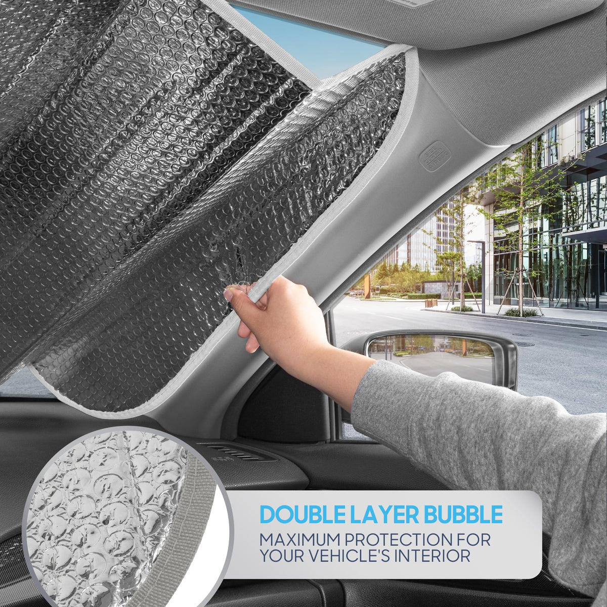 BDK sunshade beside steering wheel to show 58 x 28 inch size scale