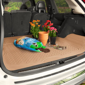 BDK demonstrating trim-to-fit cut with scissors in a vehicle trunk