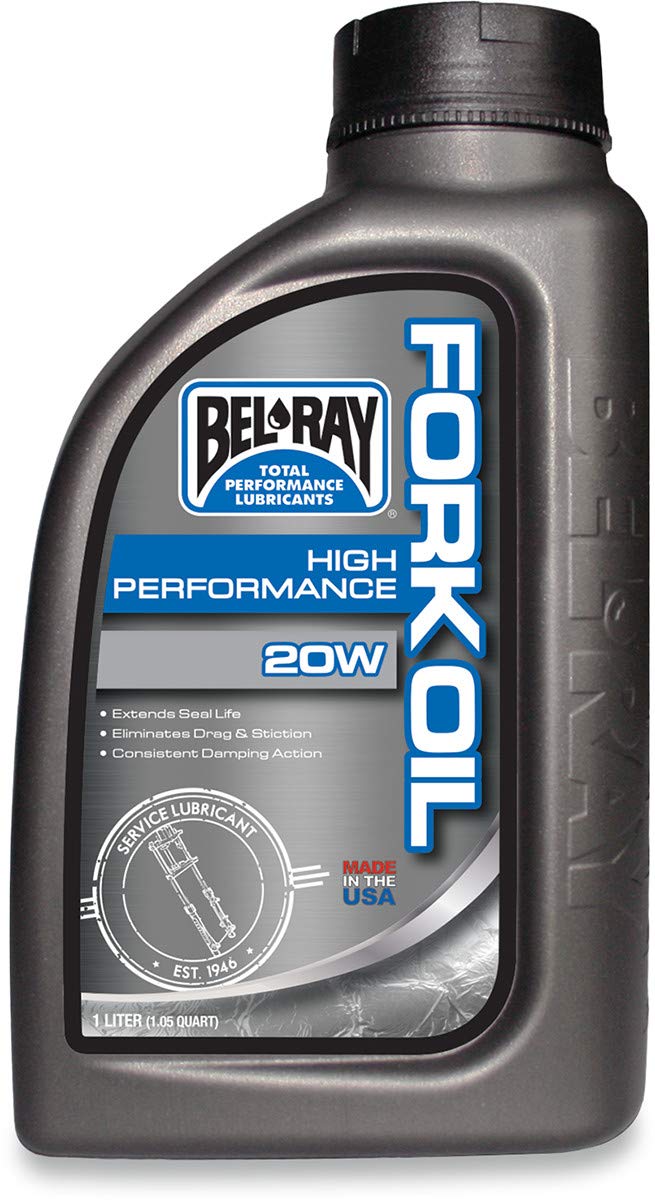 Bel-Ray High Performance Fork Oil 20W pouring into fork tube during service for clean refill and accurate level