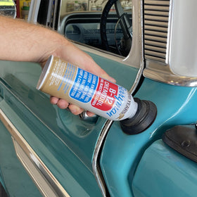 Berryman B-12 pouring into fuel tank showing safe system cleaning benefit