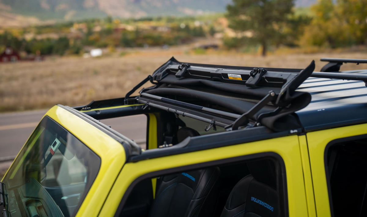 Bestop Sunrider installed with Jeep driver enjoying open-air driving and sun exposure