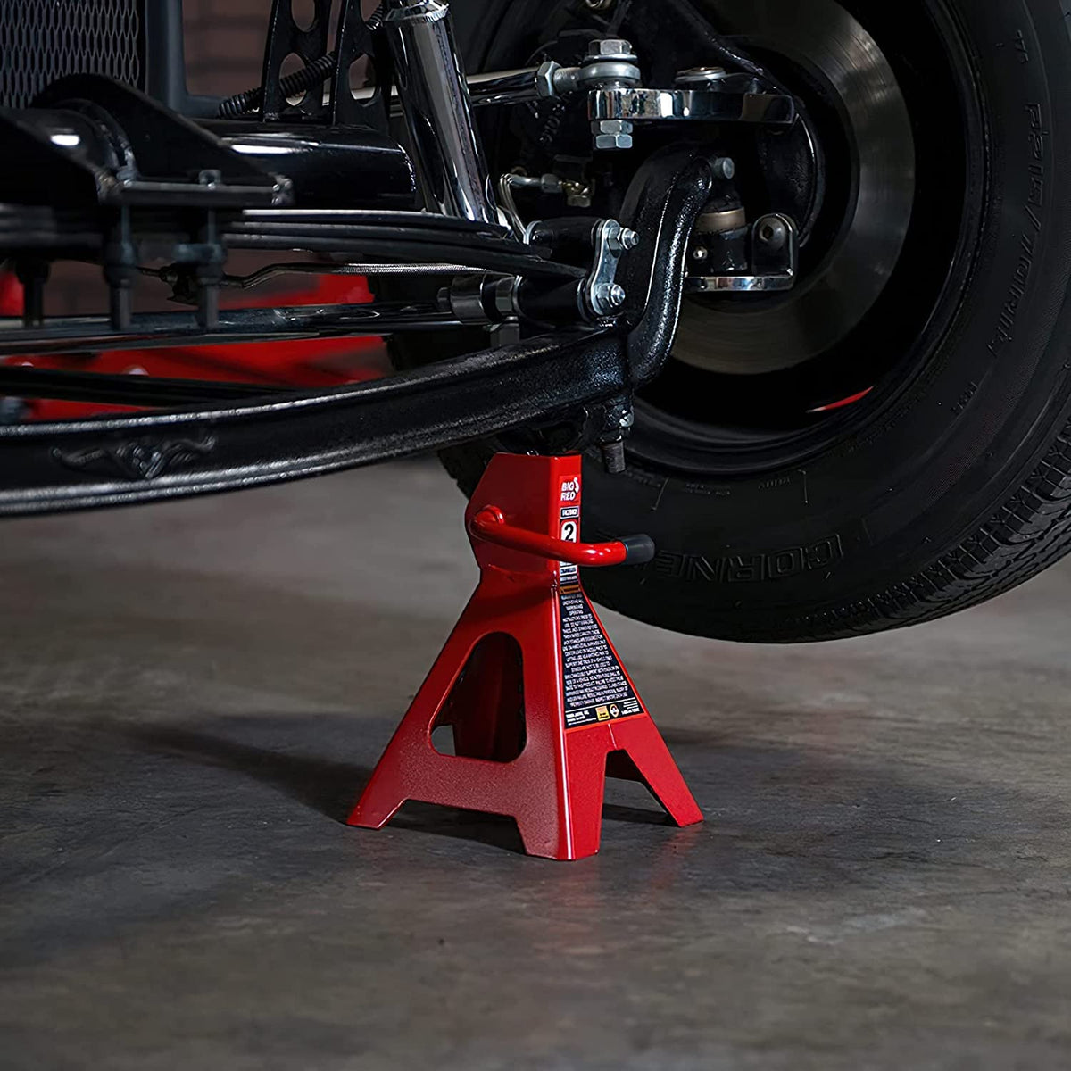 BIG RED jack stand next to tape measure showing adjustable height range clearly