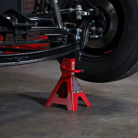 BIG RED jack stand next to tape measure showing adjustable height range clearly