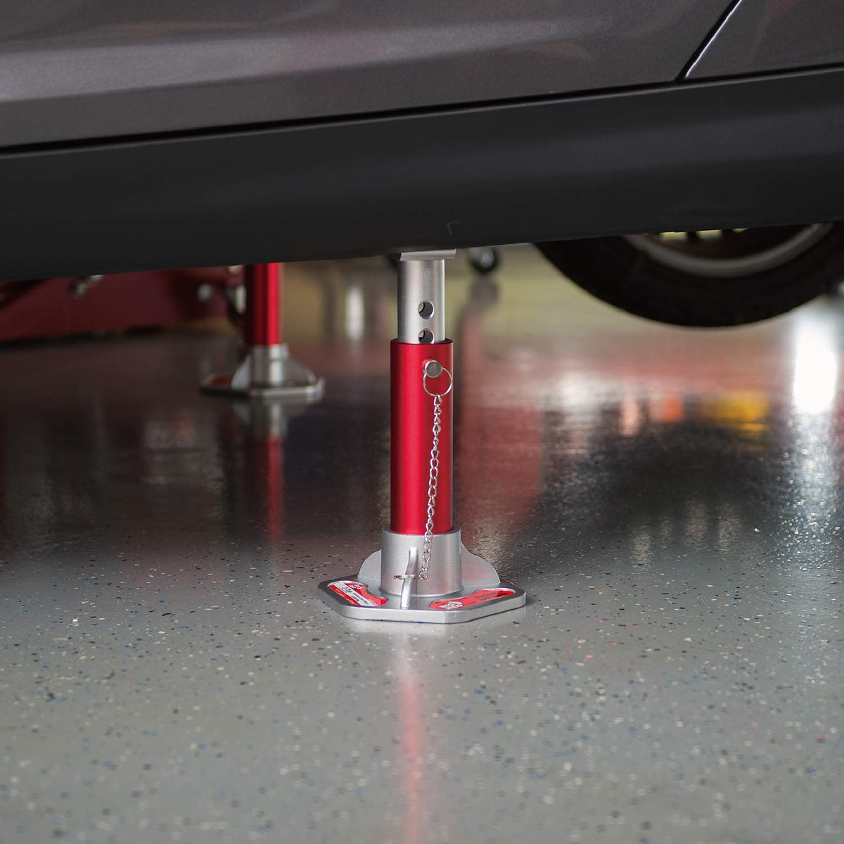BIG RED in use under car highlighting stable support while performing maintenance
