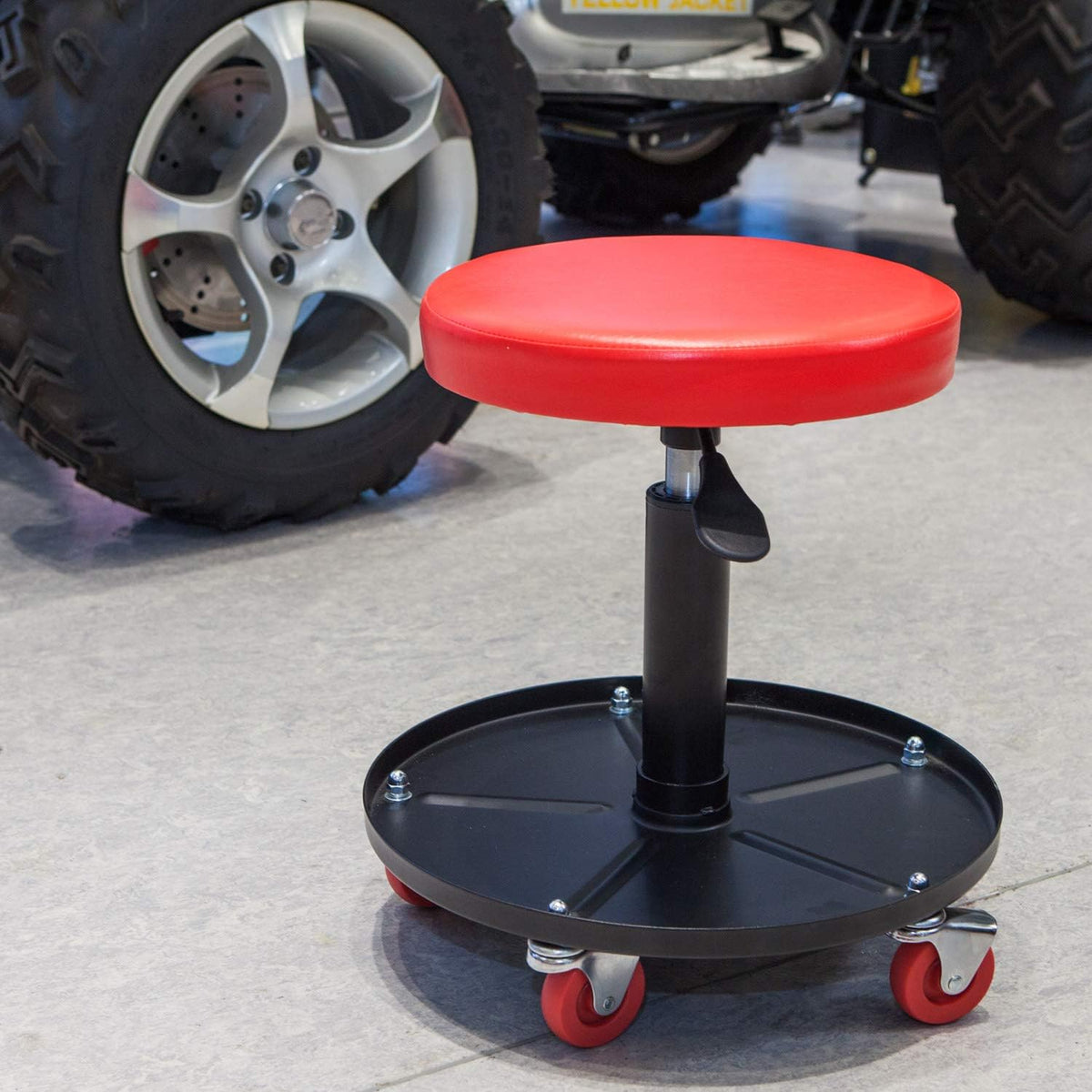 BIG RED mechanic using stool in garage to improve workflow