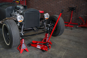 BIG RED scale comparison placing stand beside hydraulic jack to show size