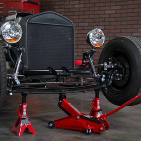 BIG RED jack next to tape measure showing low-profile lift range for fitment benefit