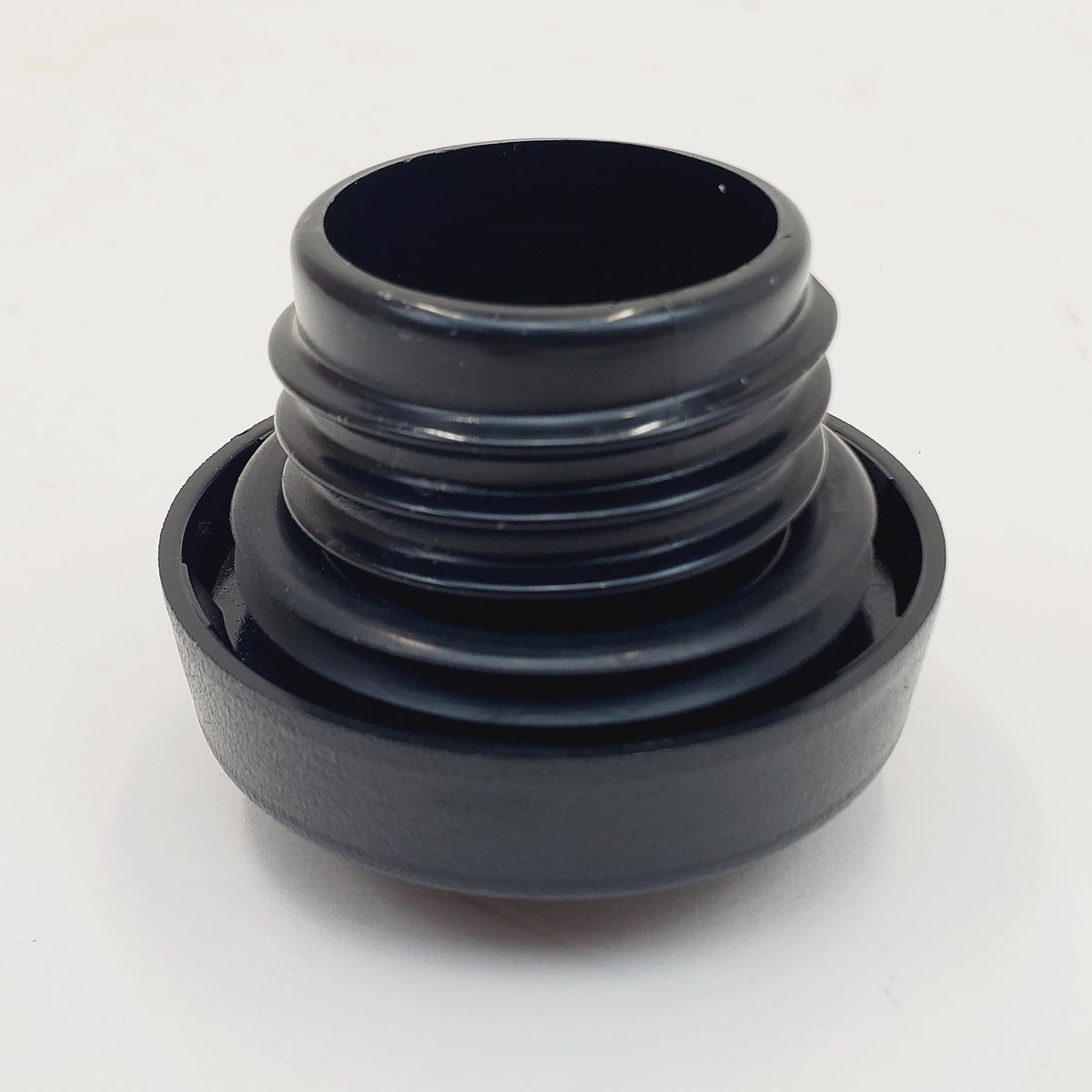 Billet Proof Designs cap on workbench near tools showing easy replacement and practical use