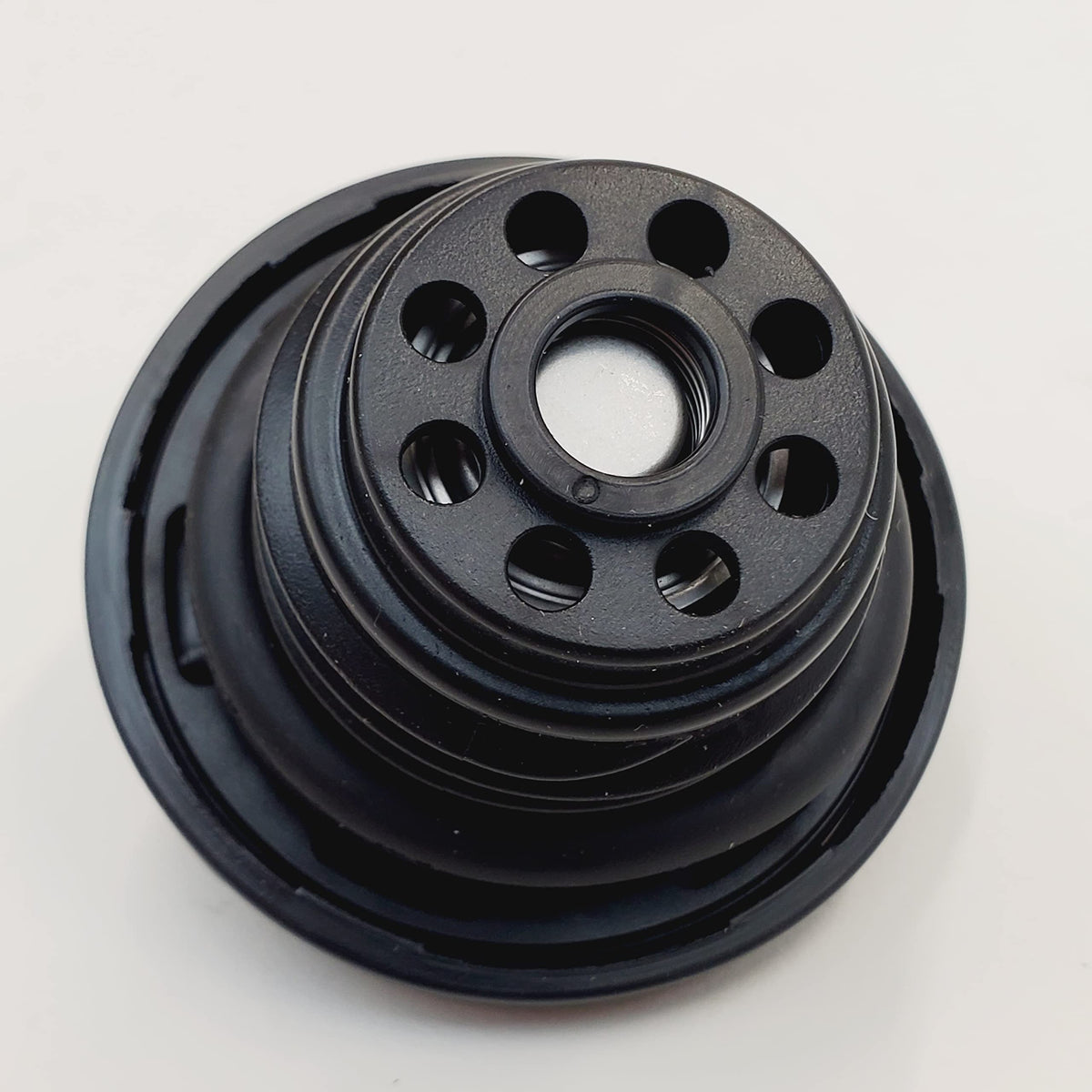 Billet Proof Designs cap beside a coin for size and fit reference ensuring compatibility