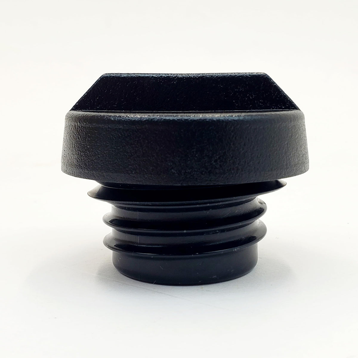 Billet Proof Designs cap beside a coin for scale to show compact size and easy handling