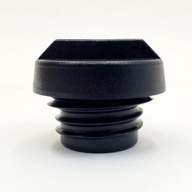 Billet Proof Designs cap beside a coin for scale to show compact size and easy handling