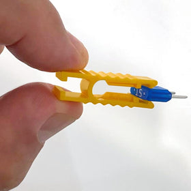 BIOFUSE mini fuse next to a coin to show scale and easy glove-box storage