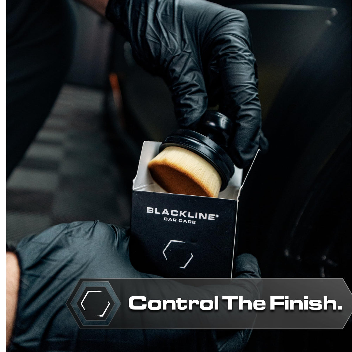 Blackline brush applying dressing to tire sidewall for streak-free appearance