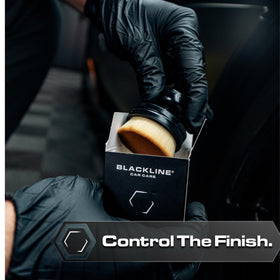 Blackline brush applying dressing to tire sidewall for streak-free appearance