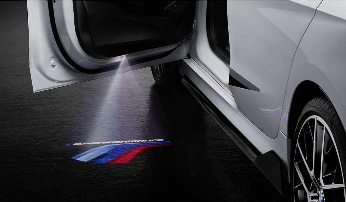 BMW M Performance projected logo on pavement at night showing clear Motorsport-color illumination