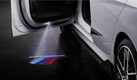 BMW M Performance projected logo on pavement at night showing clear Motorsport-color illumination