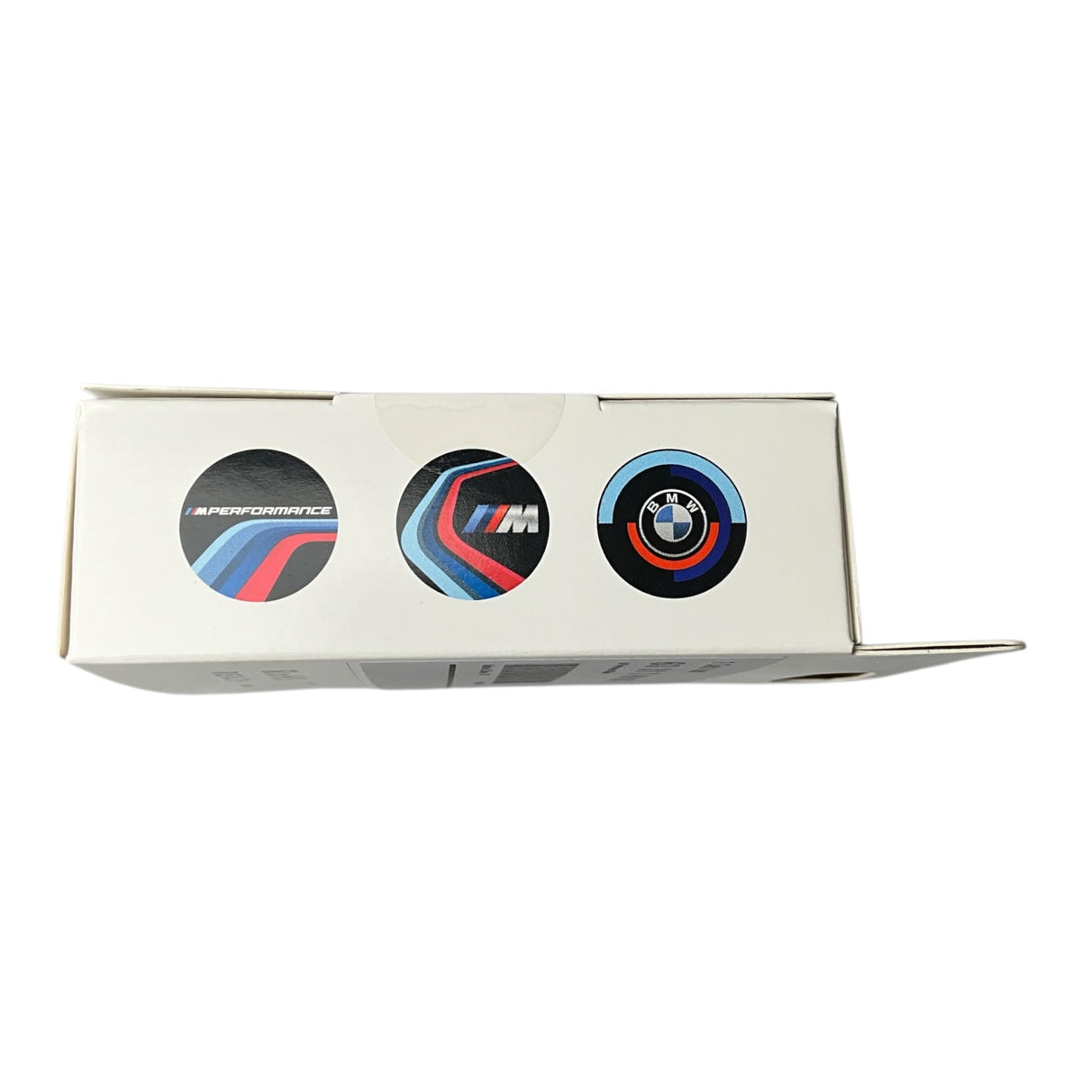 BMW M Performance slides beside a coin for scale showing compact size and easy handling
