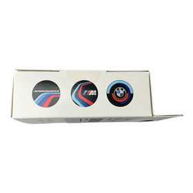 BMW M Performance slides beside a coin for scale showing compact size and easy handling