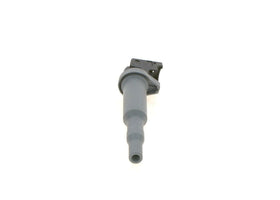 Bosch ignition coil next to ruler size comparison illustrating compact direct-fit design