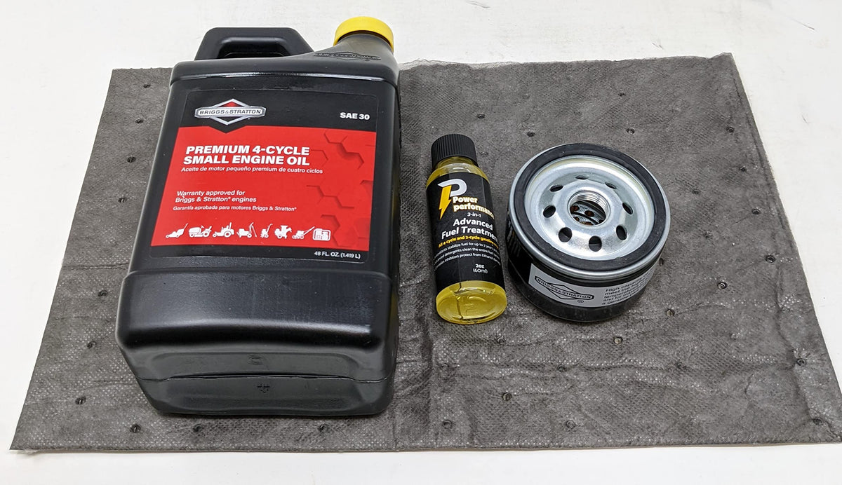 Briggs & Stratton kit in use on riding mower showing neat oil change with absorbent pad