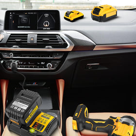 BTRUI DCB112 plugged into a truck accessory outlet powering a battery on a job site