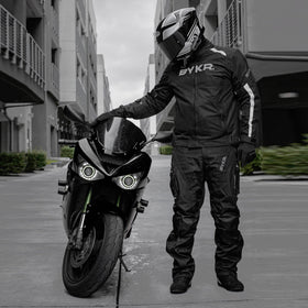 BYKR overpants beside helmet for scale and quick on/off convenience