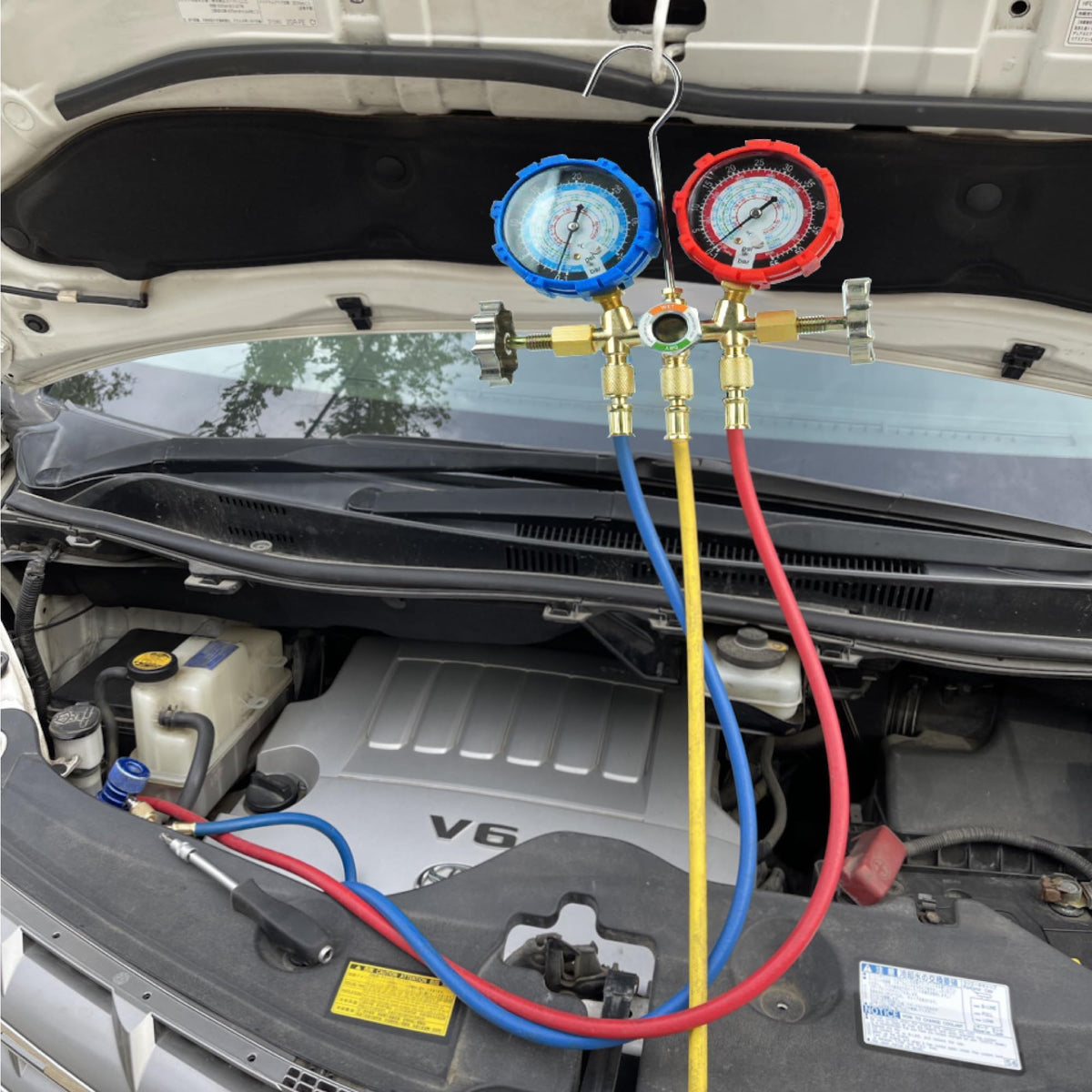 CALPOSE in use on vehicle AC with technician connecting hoses for efficient system charging