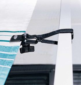 Camco de-flapper installed on RV awning stabilizing fabric in wind