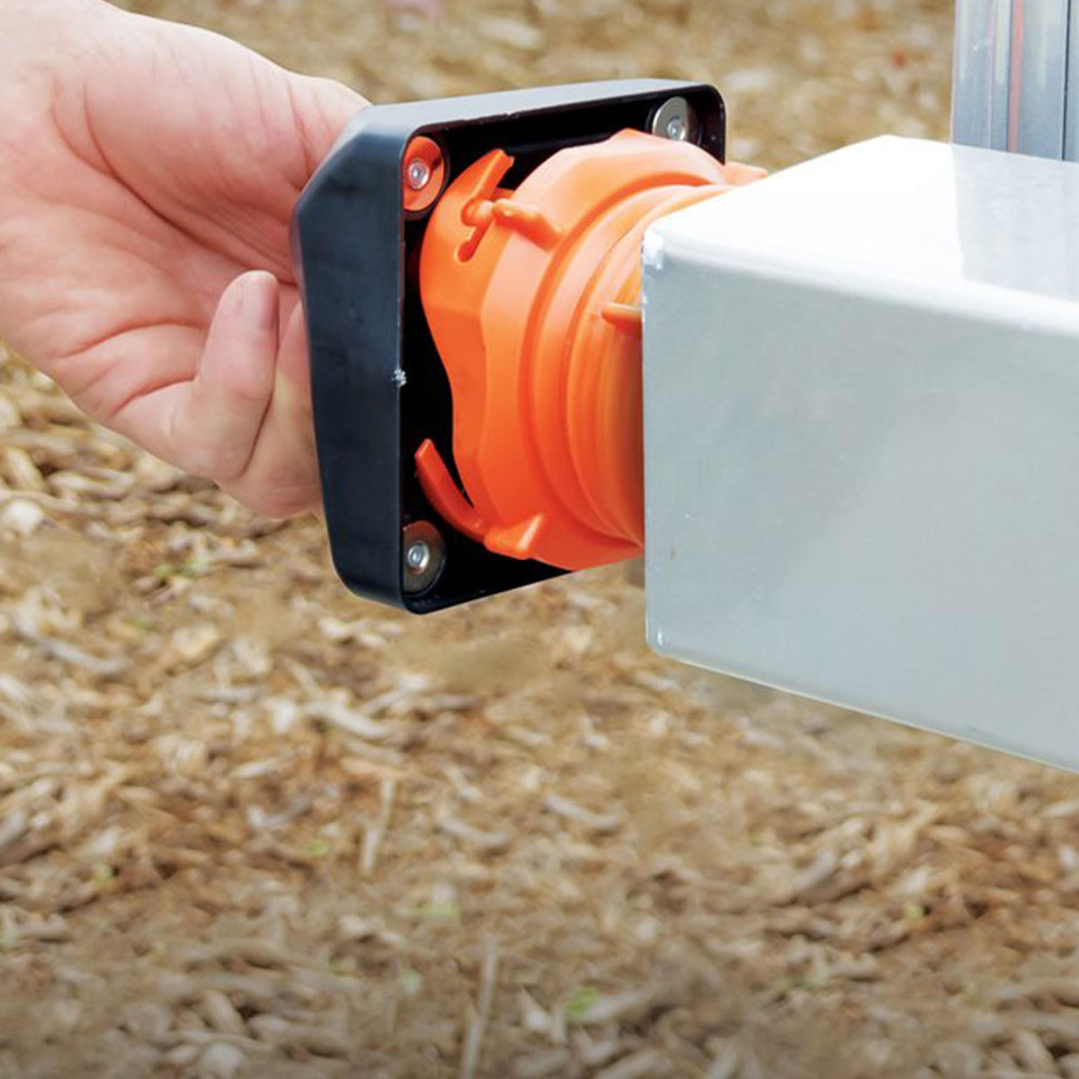 Camco bumper cap mounted on metal RV bumper preventing hose movement