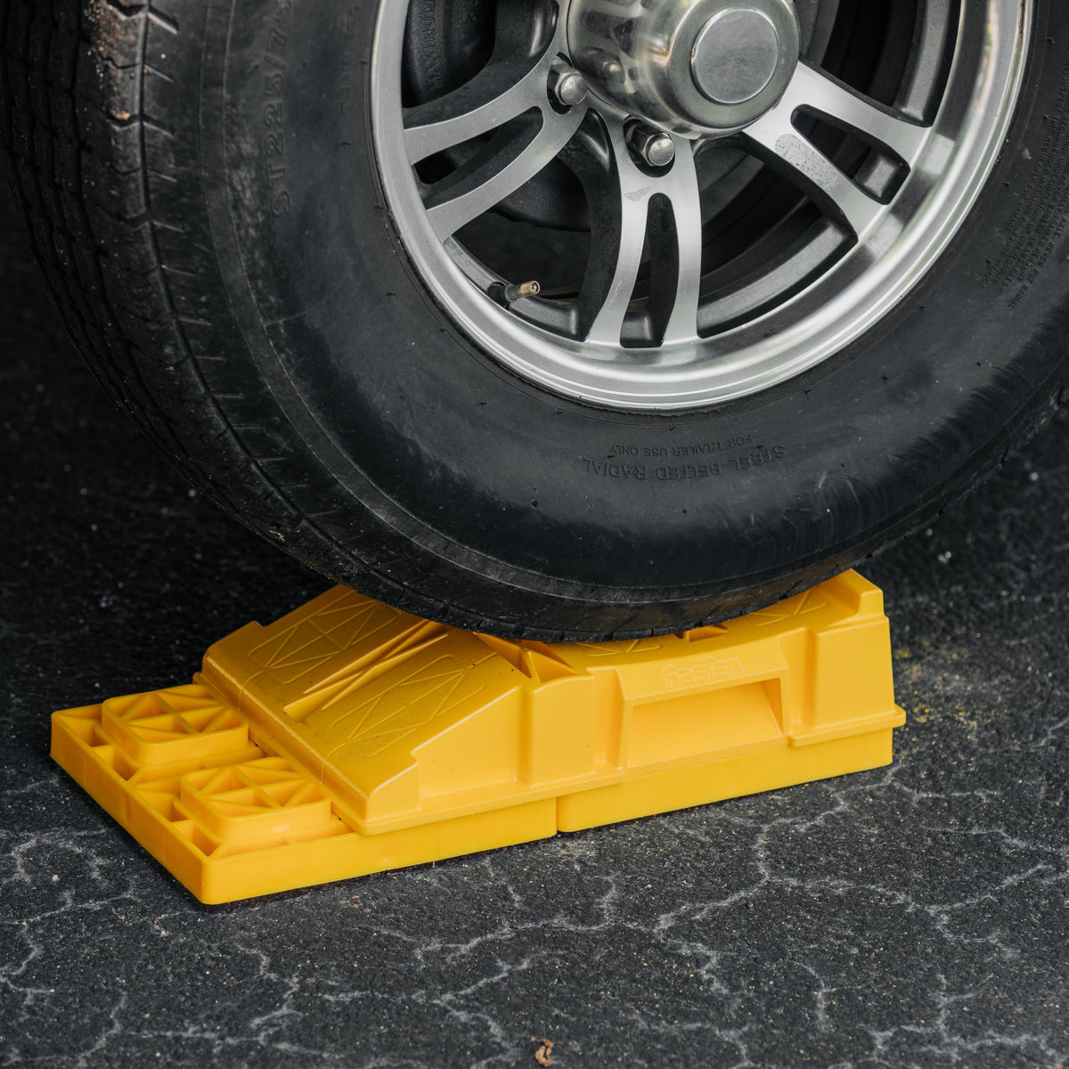 Camco FasTen ramp held in hand to show scale and effortless positioning convenience