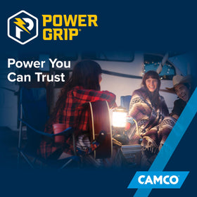 Camco PowerGrip next to hand and RV manual for compact storage and scale