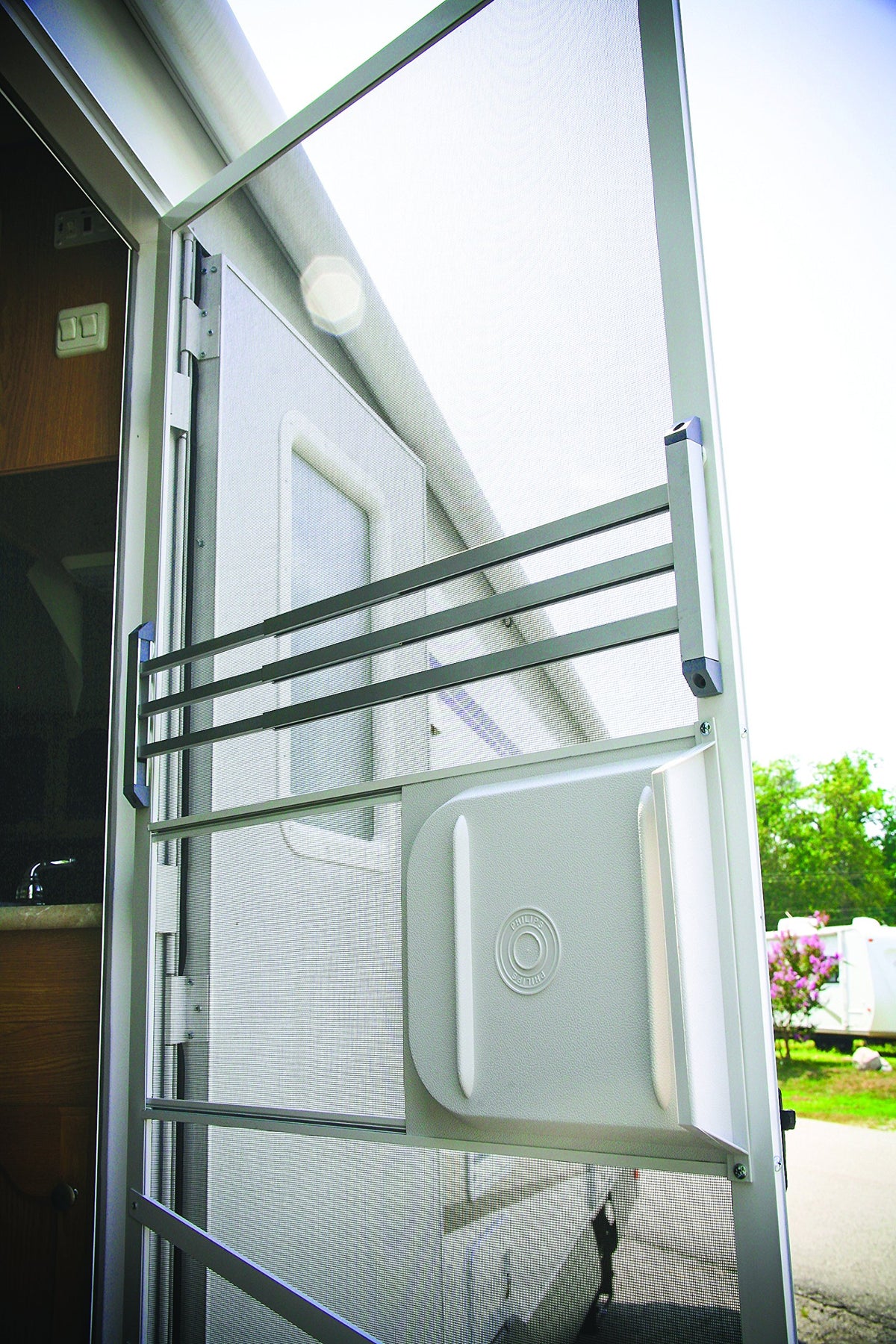 Camco push bar on RV at campground illustrating protection from pets and kids