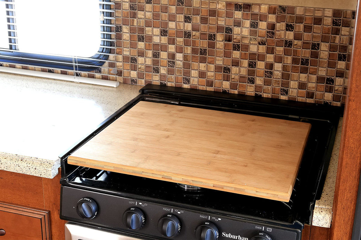 Camco rubber feet seated in burner grates to prevent rattle while driving