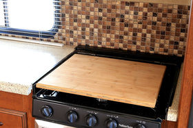 Camco rubber feet seated in burner grates to prevent rattle while driving
