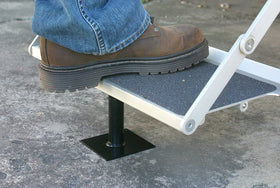 Camco brace installed under RV step providing steady, wobble-free footing