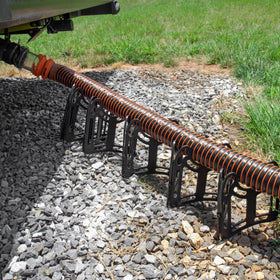 Camco Sidewinder on an RV campsite showing tidy setup and confident tank emptying