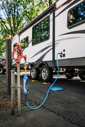 Camco filling a water bottle to show convenient access to filtered drinking water