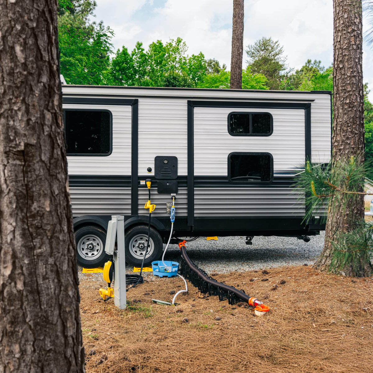 Camco TastePURE stretched across lawn comparing 75-foot reach for campsite access