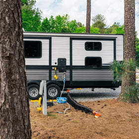 Camco TastePURE stretched across lawn comparing 75-foot reach for campsite access