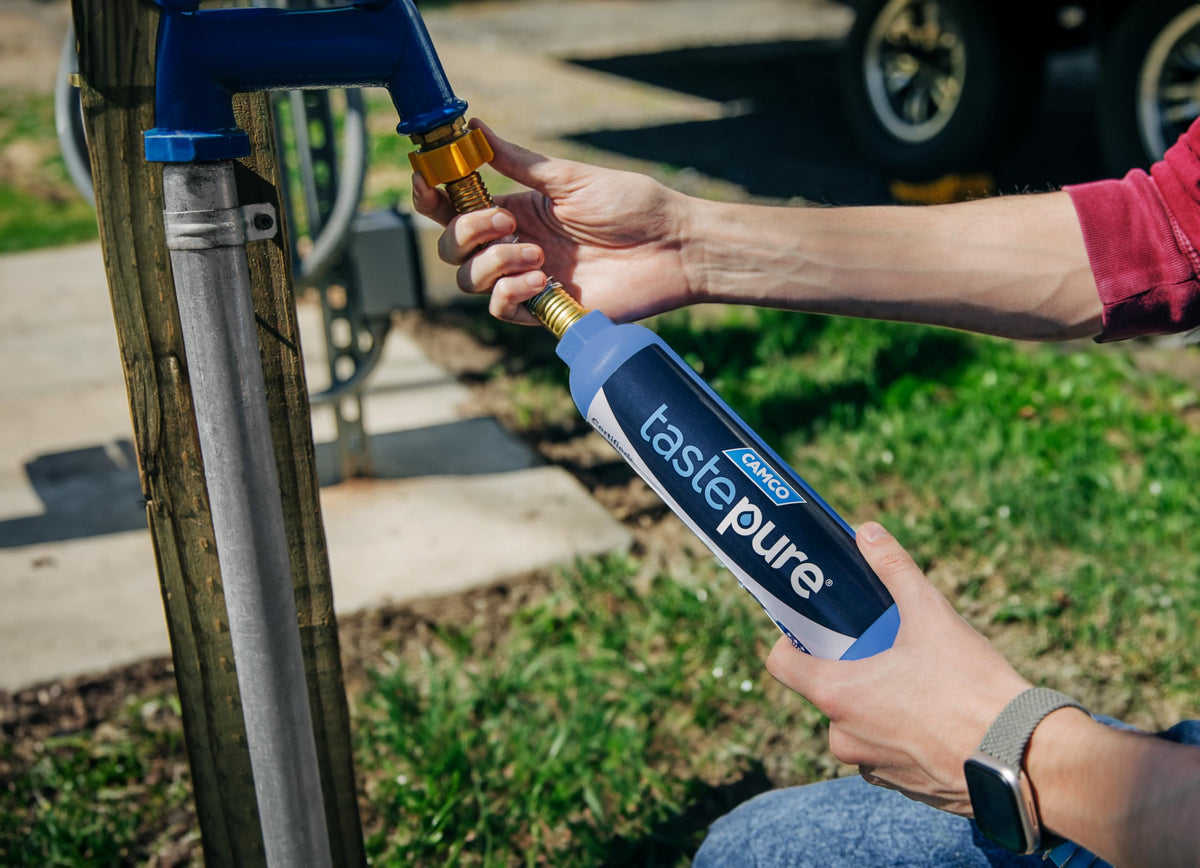 Camco Tastepure in a camping scene showing convenient filtered water use outdoors