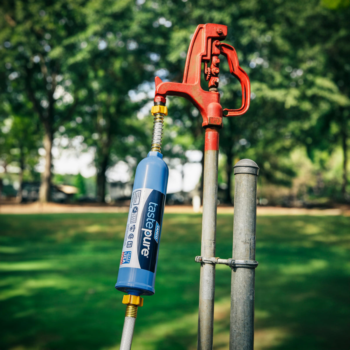 Camco hose in campsite setting providing safe water for outdoor activities