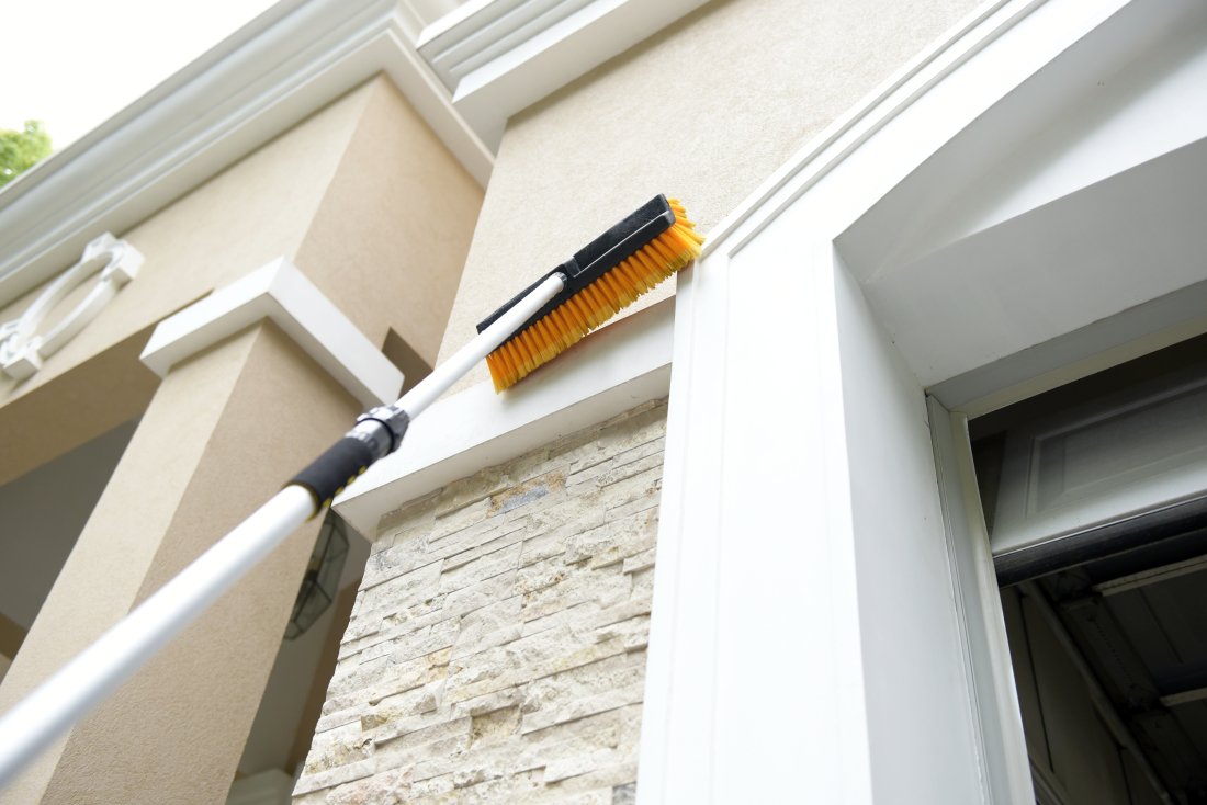 CARCAREZ brush head shown with hand and pole for scale and easy handling