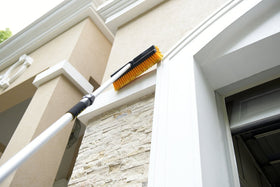 CARCAREZ brush head shown with hand and pole for scale and easy handling