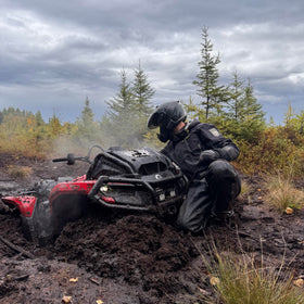 Cardo PACKTALK Edge ORV in hand for size comparison showing compact portability benefit