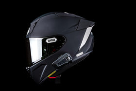 Cardo PACKTALK PRO installed on a helmet demonstrating discreet profile and clear audio benefit