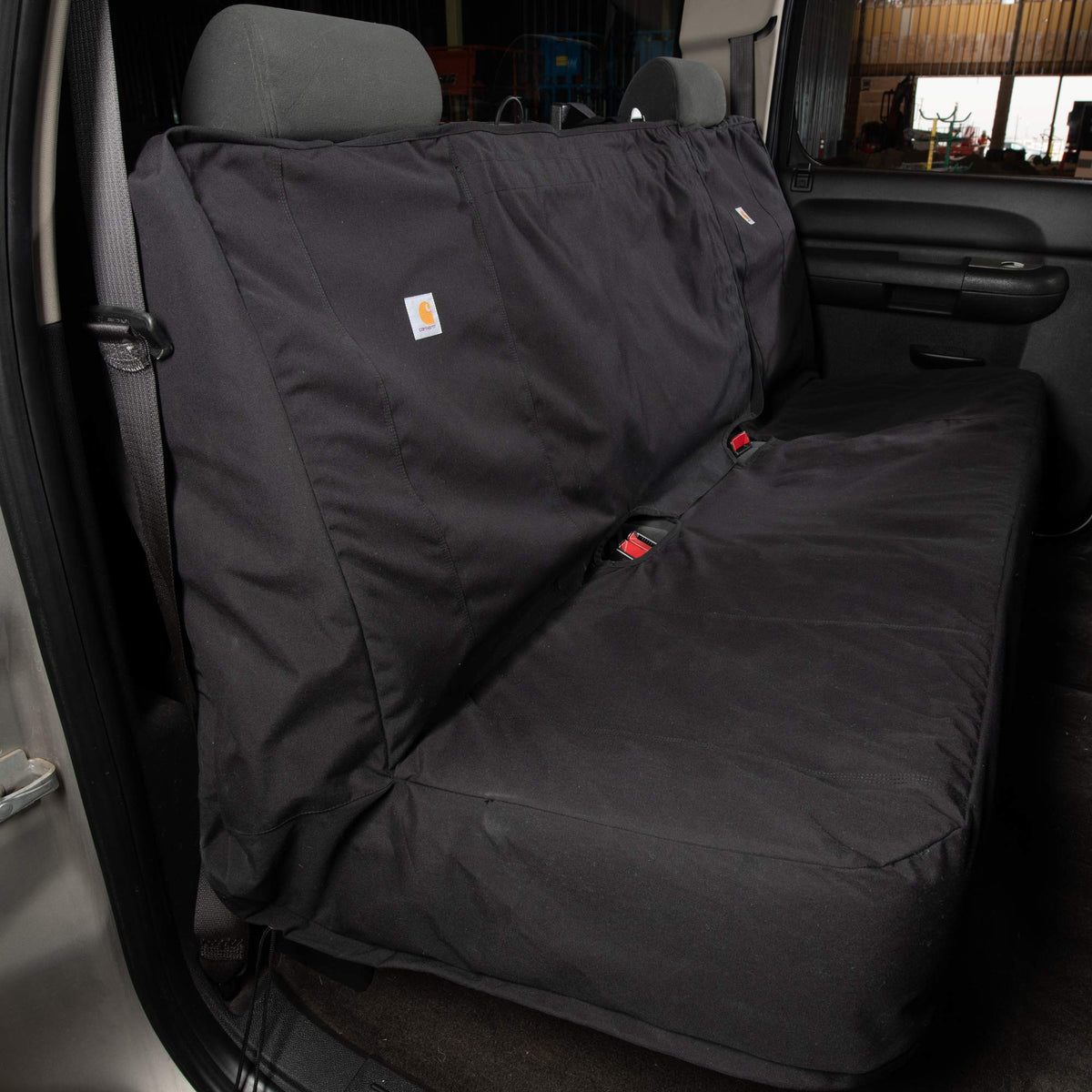 Carhartt on bench seat showing fit and scale for full-size trucks