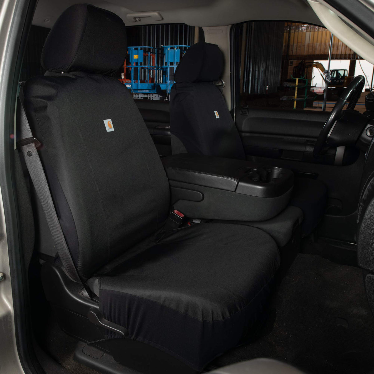 Carhartt seat cover with work boot showing size scale and protective coverage