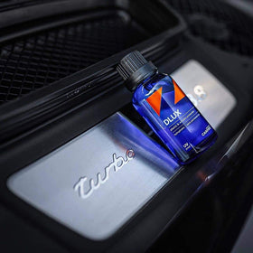CARPRO DLUX bottle with applicator pads ready for wheel and trim use